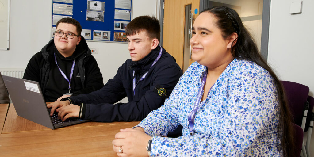 Three students sat at a table