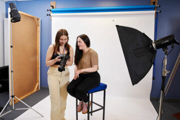 Two students looking at photos on a camera