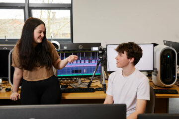 Two students using media equipment