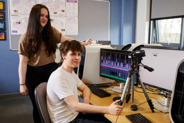 Two students using media equipment