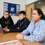 Three students sat at a table
