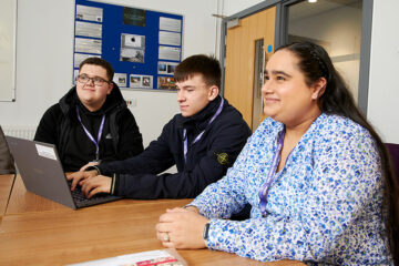 Three students sat at a table