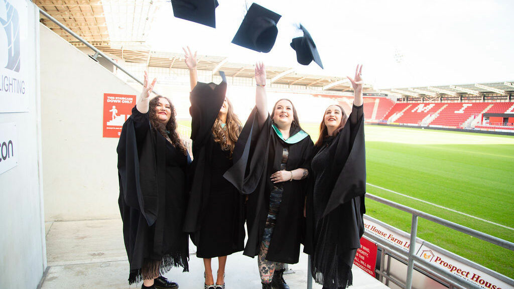 Graduation students throwing their hars up in the air
