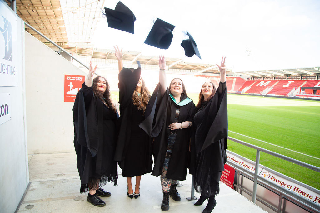 Graduation students throwing their hars up in the air