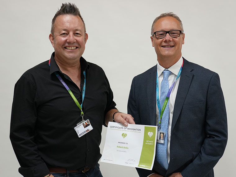 Rob Bellis receiving a Kudos award from Principal and CEO Jason Austin