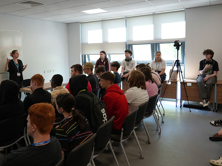 People sat listening to a talk during the HE Fair