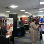 People chatting at the HE Fair