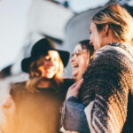 Three people smiling
