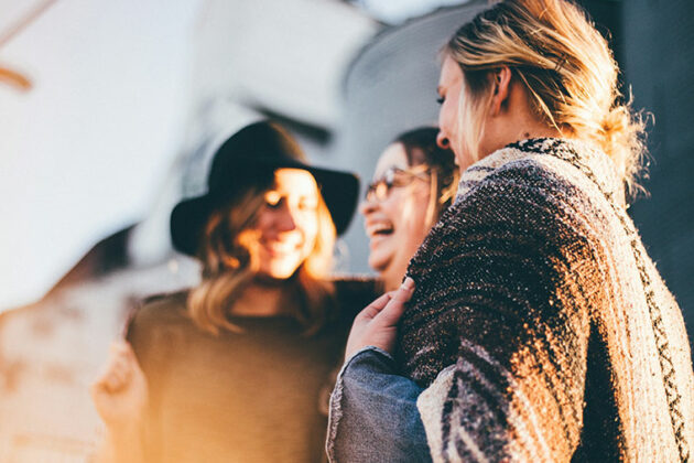 Three people smiling