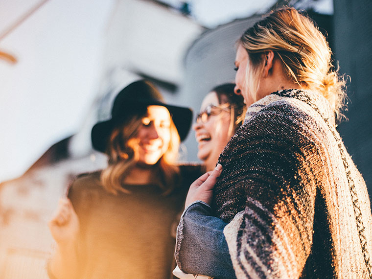 Three people smiling