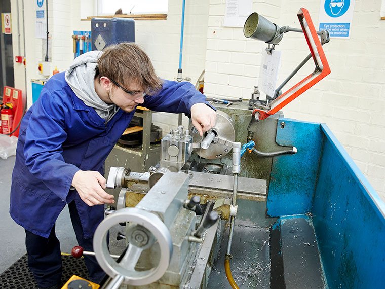 An engineering student using machinery