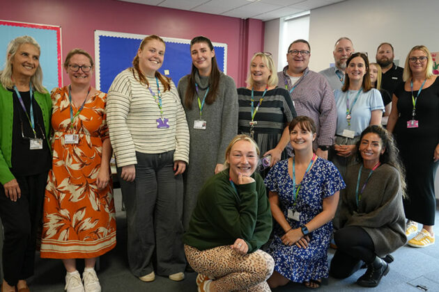 A group of staff members standing with Beth Hall at her leaving event