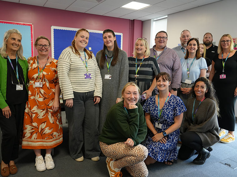 A group of staff members standing with Beth Hall at her leaving event
