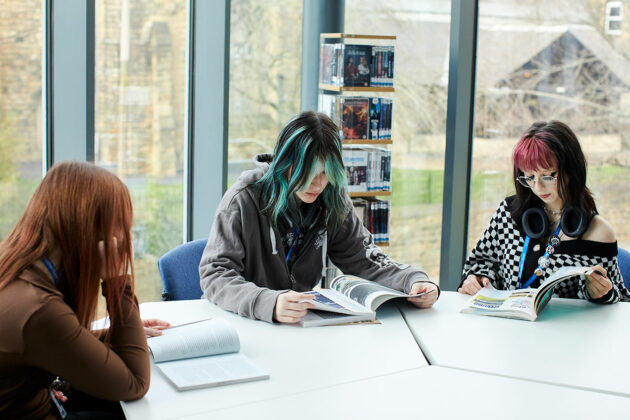 Three students sat at a table