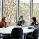 Three UCR students sat at a table