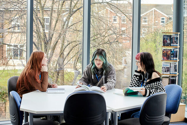 Three UCR students sat at a table