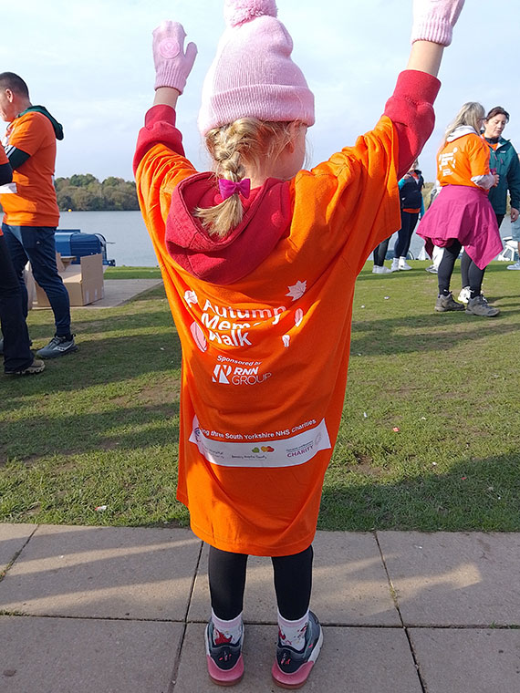 A child supporting the NHS Autumn Memory Walk 2025