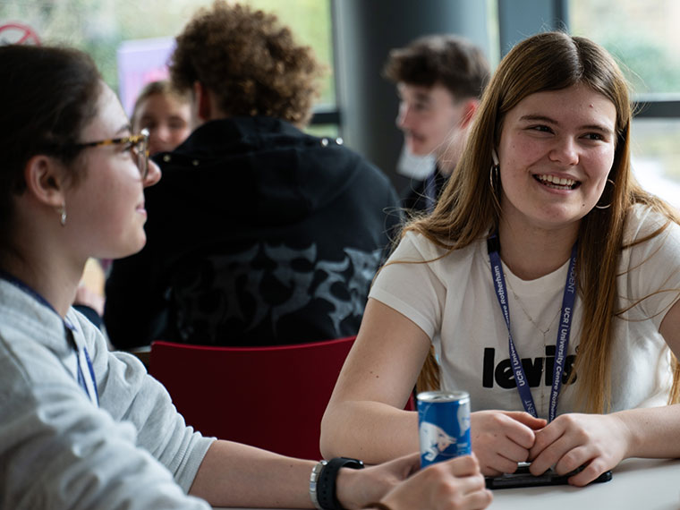 Students sat at desks socialising in the UCR